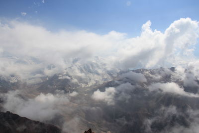 Low angle view of clouds over mountains