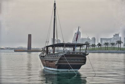 Boat moored in sea against sky