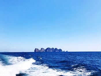 Scenic view of sea against clear blue sky