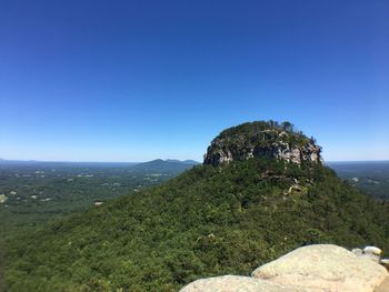 Scenic view of mountain against clear blue sky