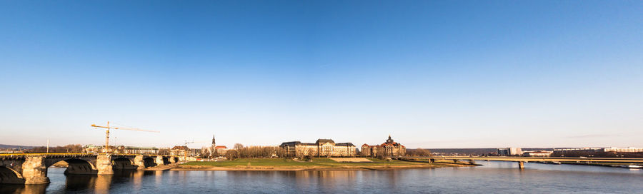 View of bridge over river against blue sky