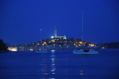 Boats in harbor at night