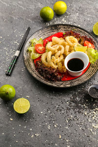 High angle view of food in plate on stone tray