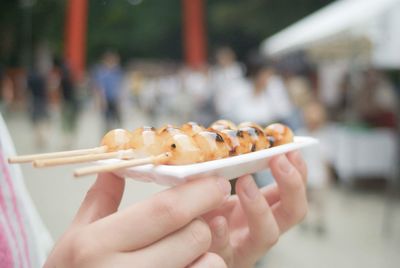 Close-up of hand holding ice cream