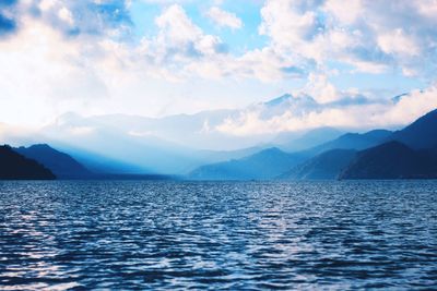 Scenic view of mountains against cloudy sky