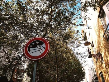 Low angle view of road sign against sky