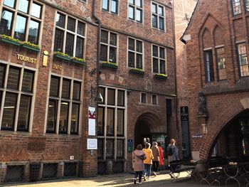 People standing on street against building