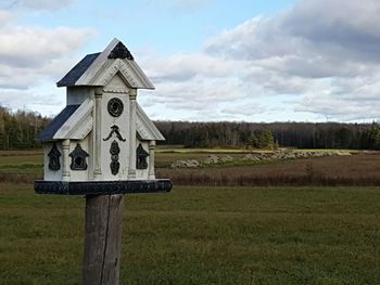 Built structure on field against sky