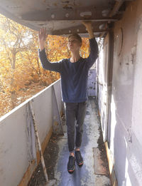 Full length portrait of young man standing outdoors