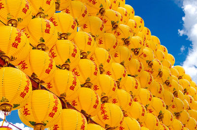 Low angle view of lanterns hanging against sky