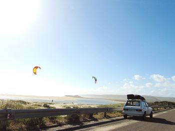 Hot air balloon at beach against clear sky