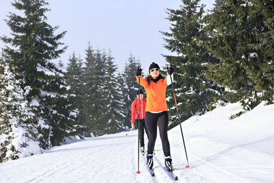 Full length of woman skiing on snow covered mountain