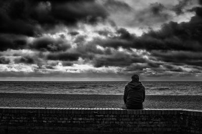 Rear view of man looking at view against sky