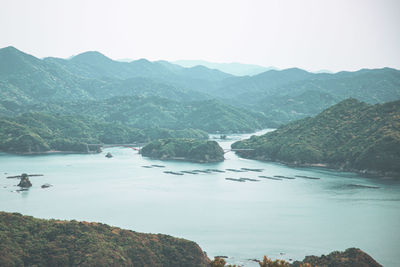 Scenic view of lake and mountains against clear sky