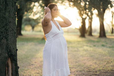 Rear view of woman standing on field