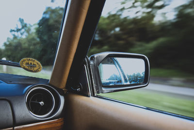 Reflection of car on side-view mirror