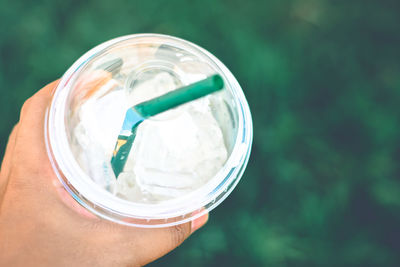 Cropped hand of person holding fresh drink