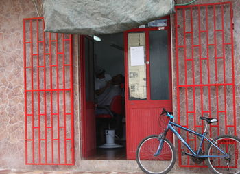 Bicycle against red door