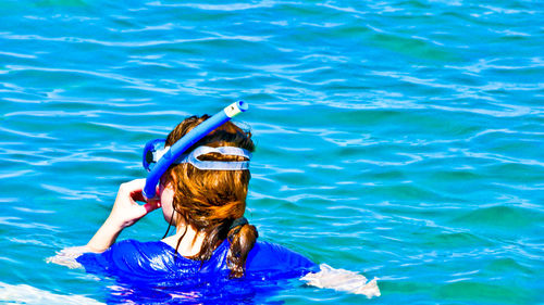 Rear view of woman in swimming pool