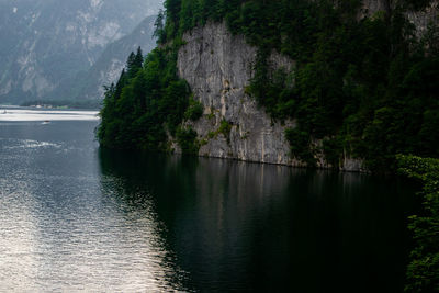 Scenic view of lake by trees against mountain