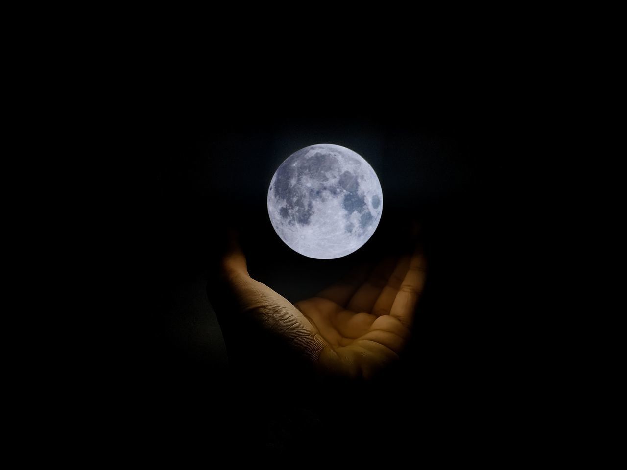 HUMAN HAND HOLDING MOON