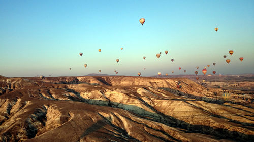 View of hot air balloons flying over rocks