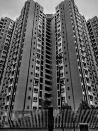 Low angle view of modern buildings in city against sky