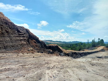 Rock formations on landscape against sky