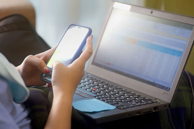 Midsection of person using mobile phone