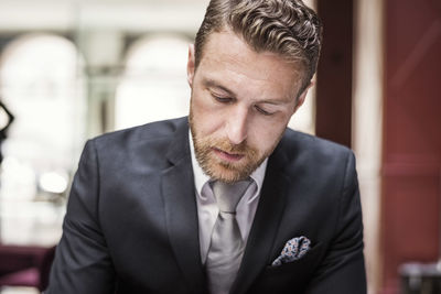 Mature businessman looking down at hotel reception