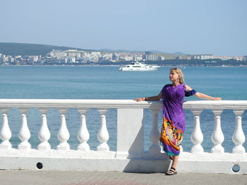 Girl looking away against sea