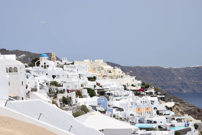 Townscape by sea against clear sky