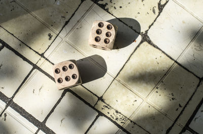 High angle view of piano keys on tiled floor