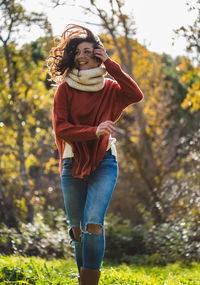 Happy woman running in park