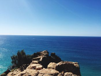 Scenic view of sea against clear blue sky