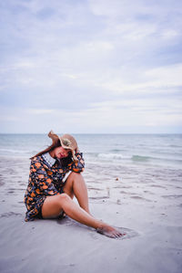 Young woman sitting on beach