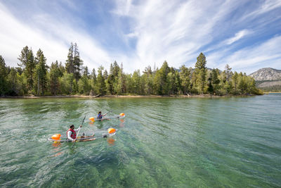 A man and woman kayaking on lake tahoe, ca