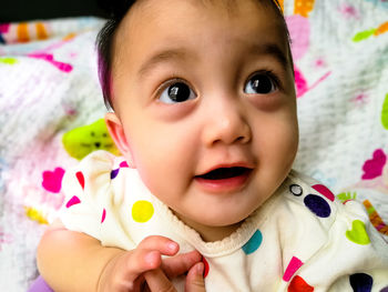 Close-up portrait of cute baby girl at home