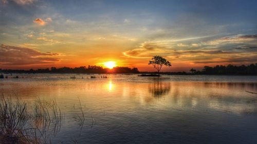 Scenic view of lake against orange sky