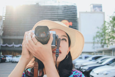 Portrait of young woman photographing