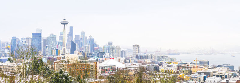 Buildings in city against clear sky