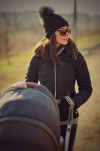 Woman pushing baby stroller