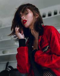 Beautiful young woman sitting at home