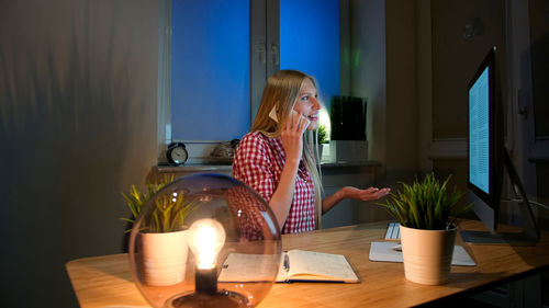 Portrait of woman sitting at home