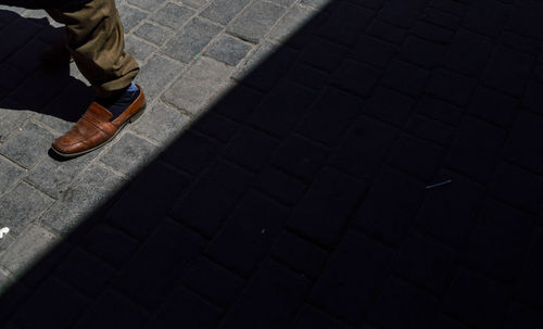 Low section of person walking on footpath