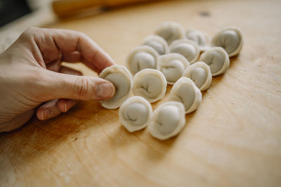 Woman arranging dumplings on cutting board