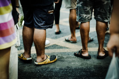 Low section of people standing on street