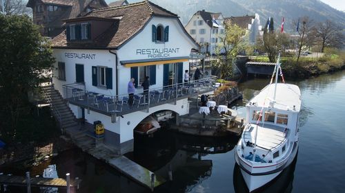 Boats in river with buildings in background