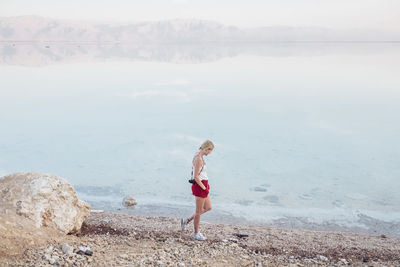 Woman on beach against sea