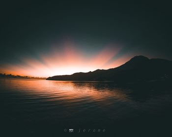 Scenic view of lake against romantic sky at sunset